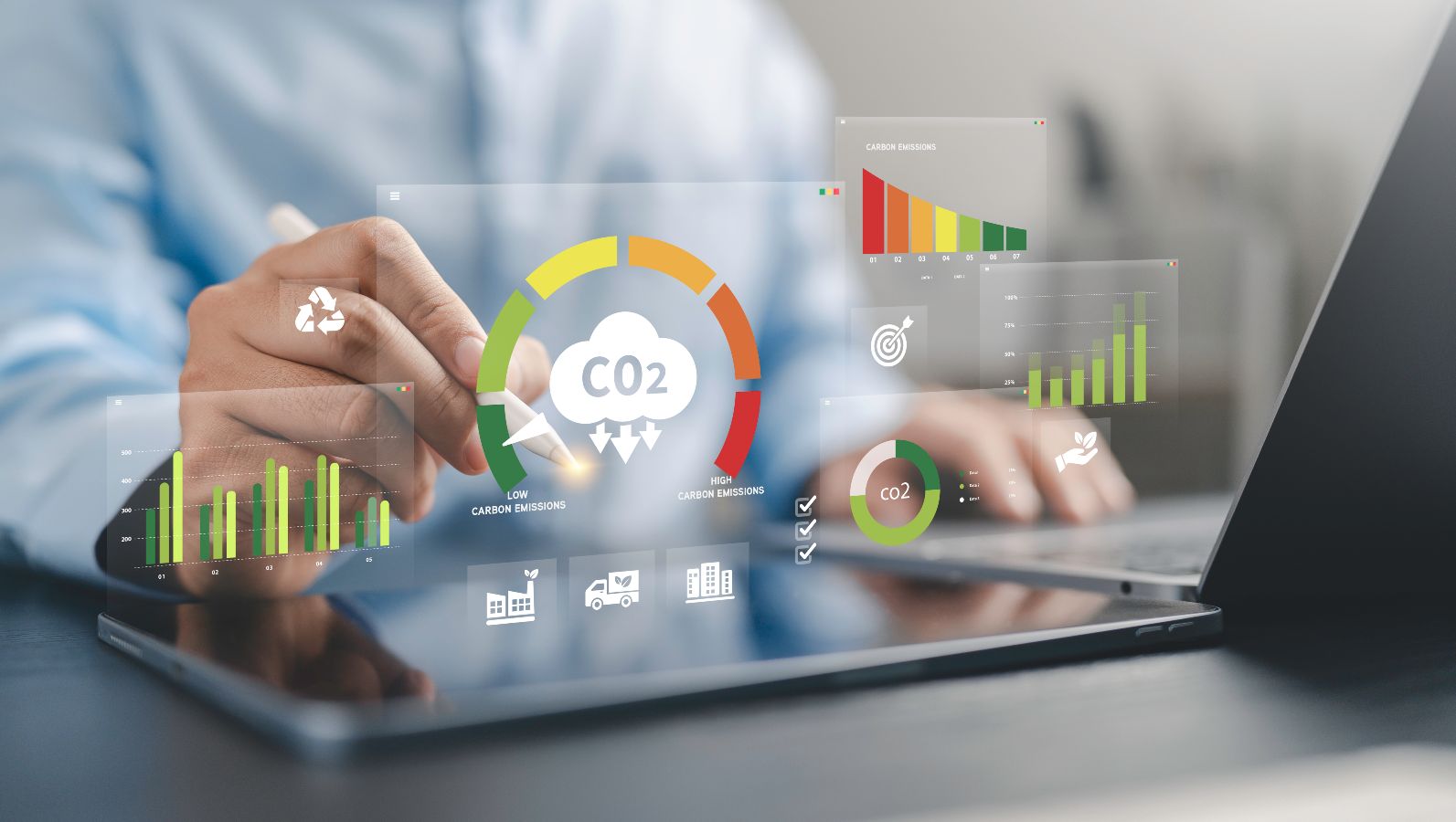 The image shows symbols for CO2 removal in front of a blurry person working with a laptop.