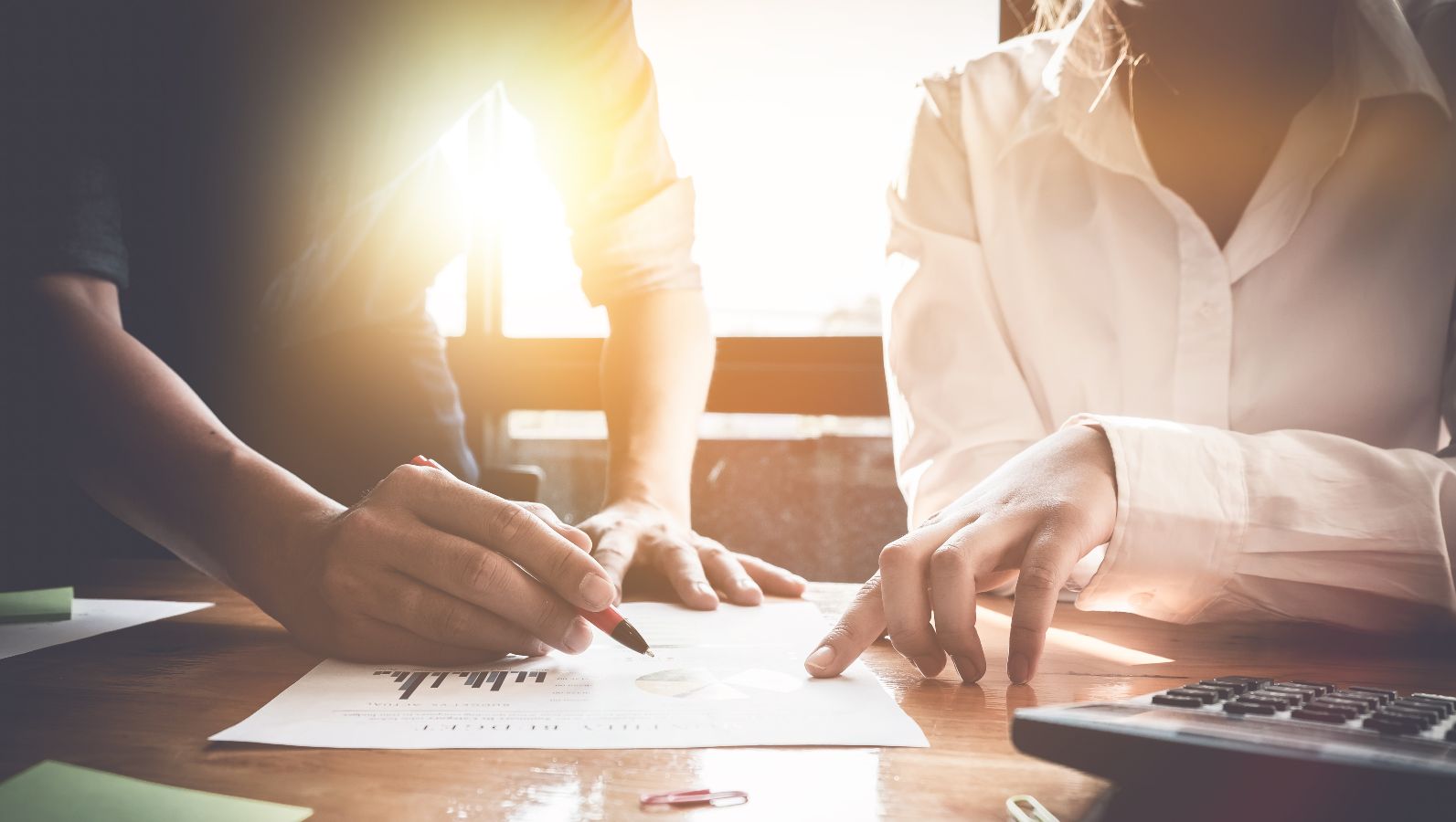 Das Bild zeigt zwei angedeutete Personen, die über Daten sitzen und diese diskutieren.